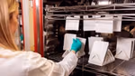 Unilever scientist testing paper-based materials to see if they will retain their quality, strength and appearance throughout the supply chain.