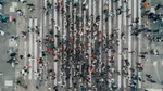 Aeriel view of crowds of people walking across a pedestrian crossing