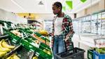 Woman browsing the fruit and veg in a supermarket