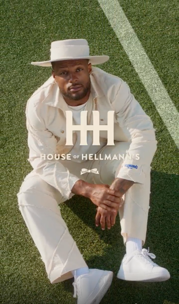 A man sat on the floor looking up wearing the new House of Hellmann’s denim collection.