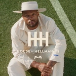 A man sat on the floor looking up wearing the new House of Hellmann’s denim collection.