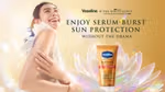 An image from the Vaseline Gluta-Hya campaign in partnership with HBO series The White Lotus. A woman smiles next to a tube of Vaseline SPF 50.
