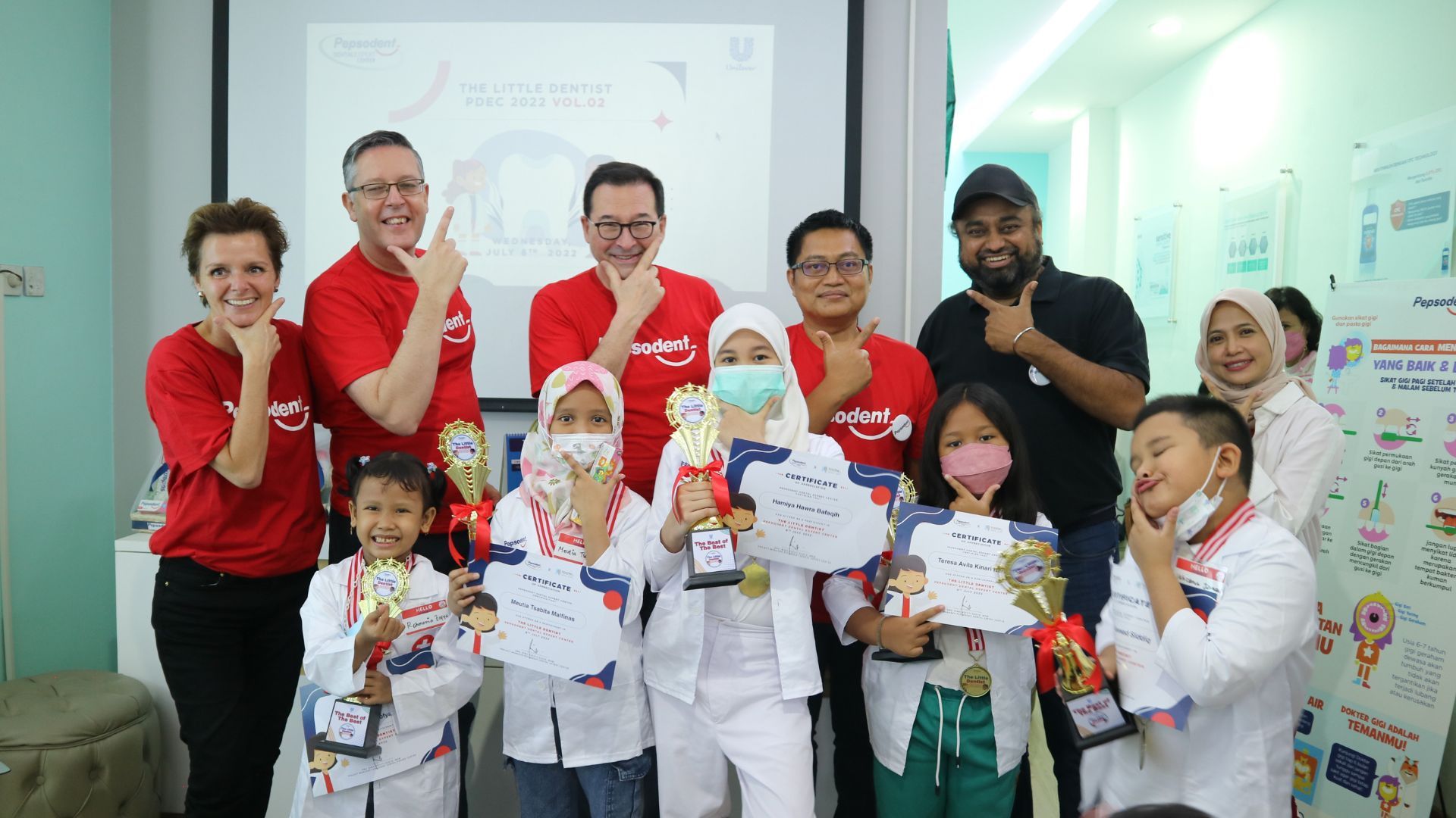 Fabian Garcia, President of Unilever Personal Care, wearing a yellow tunic and holding a lantern on a visit to Indonesia