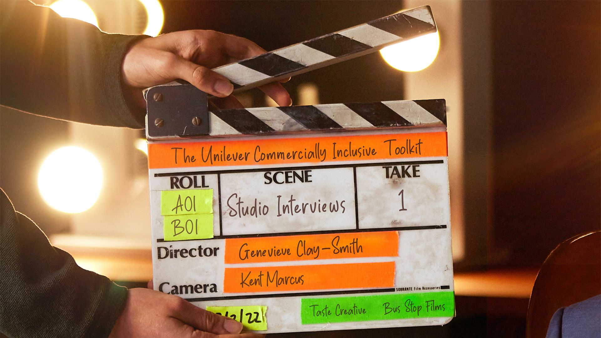Hands operating a clapperboard 