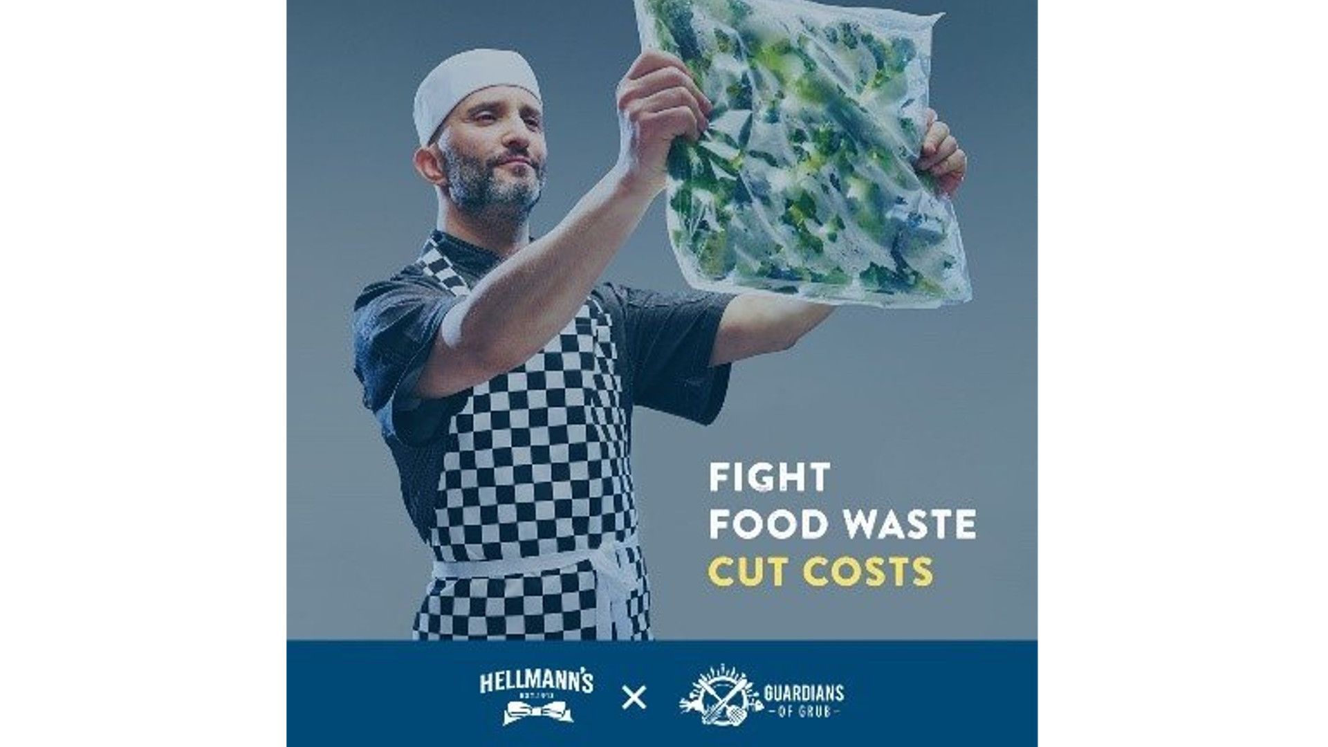 Chef holding bag of salad leaves up