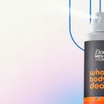 A Dove Men+Care aerosol can shown partially on the right side against a soft gradient background, with curved blue lines above the can.