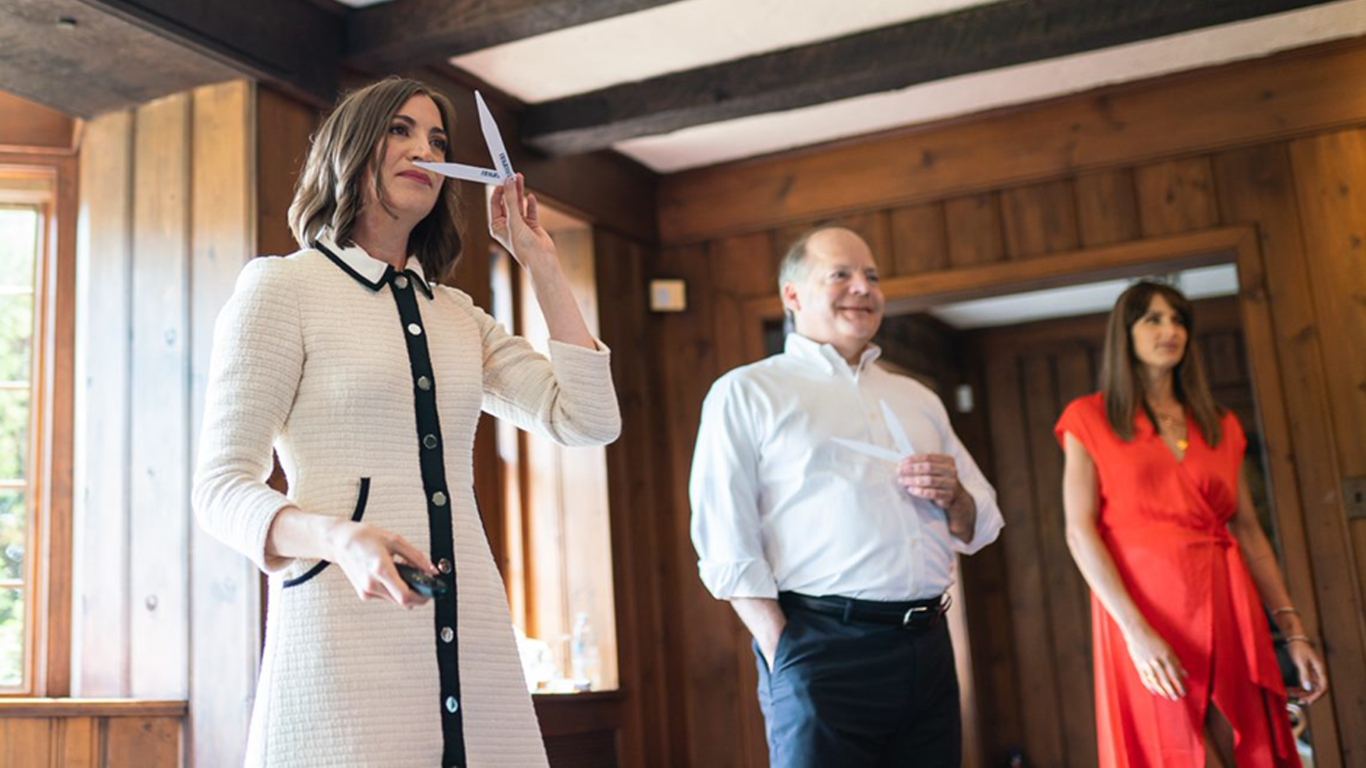Noemie Lottiau, Global Fragrance Design Leader at Axe, sniffing scent sample cards. Two other people are blurred in the background. 