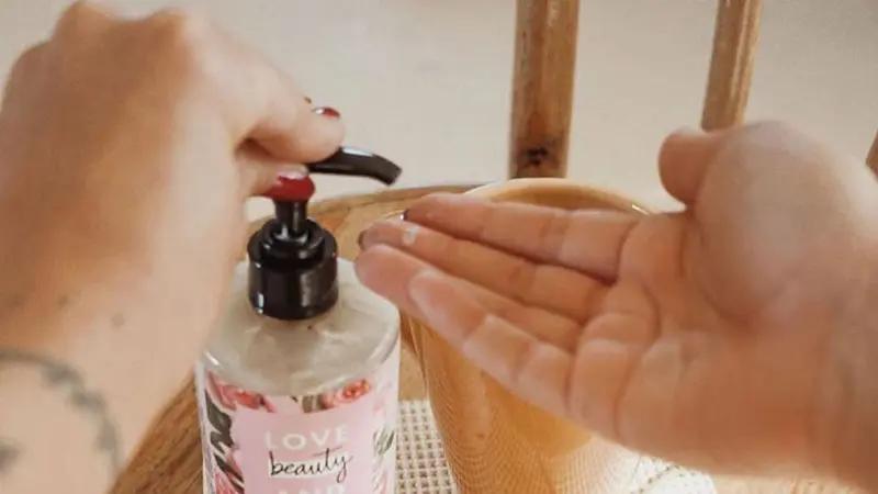 A person using Love Beauty and Planet handwash