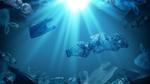 A photo of plastic bottles and bags floating in a blue ocean as sun beams into the water from above.