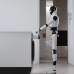 A white-and-black humanoid robot stands beside a modern washing machine in a laundry area, pouring detergent into the open detergent drawer.