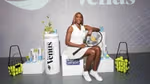 Tennis player Venus Williams at a Dove Keep her Confident launch event. Venus is sitting, holding a tennis racket and smiling at the camera.