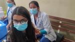 Young woman being vaccinated