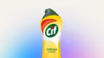 Bottle of Cif Lemon cleaning cream against a soft blue and purple background
