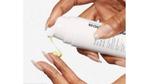 A Dermalogica product being dispensed onto someone’s fingers.
