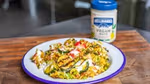 Plate of food in the foreground with a jar of Hellmann’s vegan mayonnaise in the background.