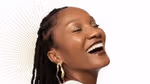 An image to promote Dove Regenerative dermocosmetics skincare products. A Black woman is shown in side profile, smiling. Background is white with gold dots.