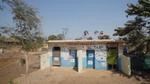 A block of toilets colourfully decorated in blue and cream.