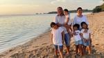 Lemuel on the beach with wife and four daughters