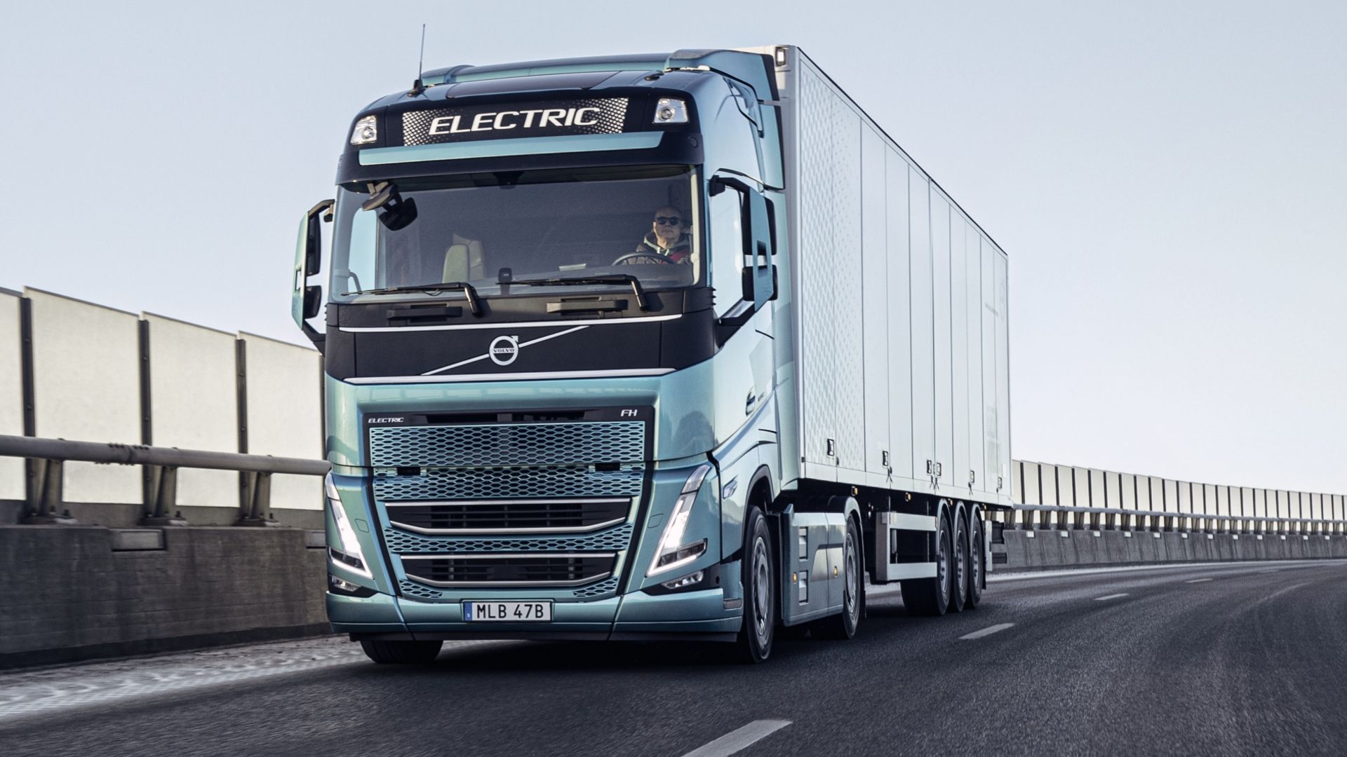 Blue metallic electric truck on a road 