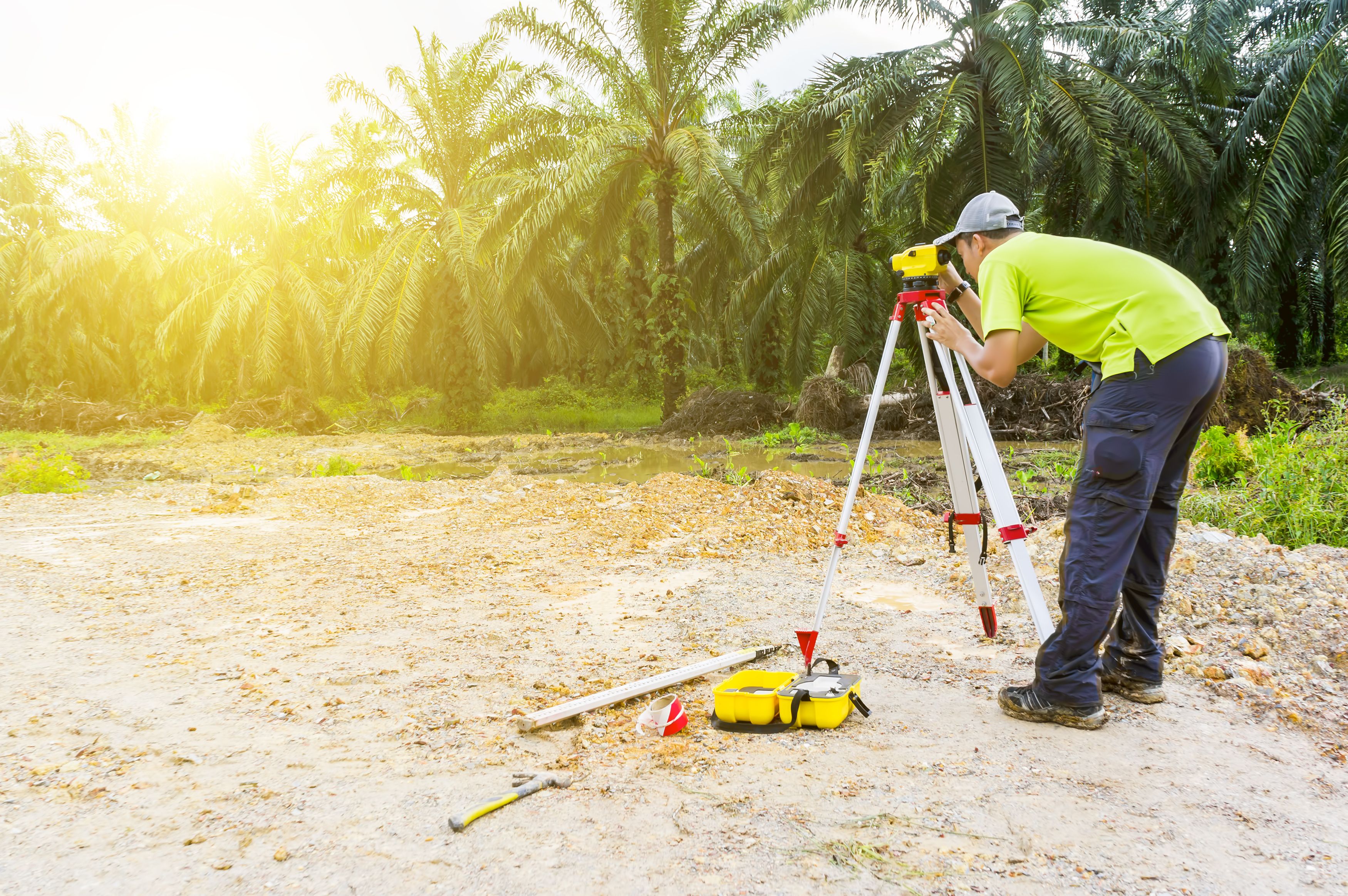 A professional boundary surveyor on a plantation