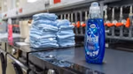 Bottles of Persil Wonder Wash and a stack of towels on top of washing machines in Unilever’s laundry detergent testing lab.