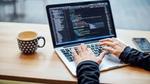 Woman working on coding via a laptop