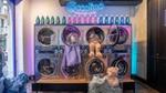 Coccolino Wonder Wash laundrette. 8 washing machines and bottles of detergent placed on top.