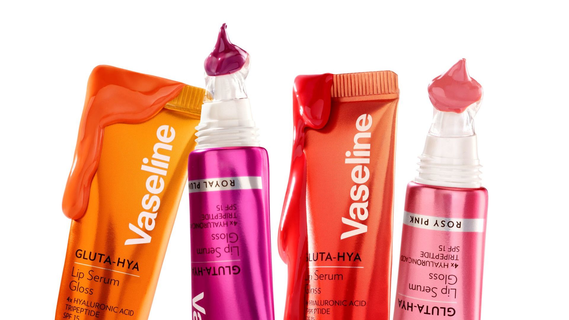 Four brightly coloured tubes of Vaseline Gluta Hya lip serum with product dripping from the tubes set on a white background.