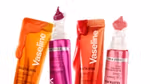 Four brightly coloured tubes of Vaseline Gluta Hya lip serum with product dripping from the tubes set on a white background.