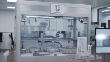 The ‘Ariana’ robot used to develop Dove hair products for Unilever. A large, glass-fronted box with a device inside.
