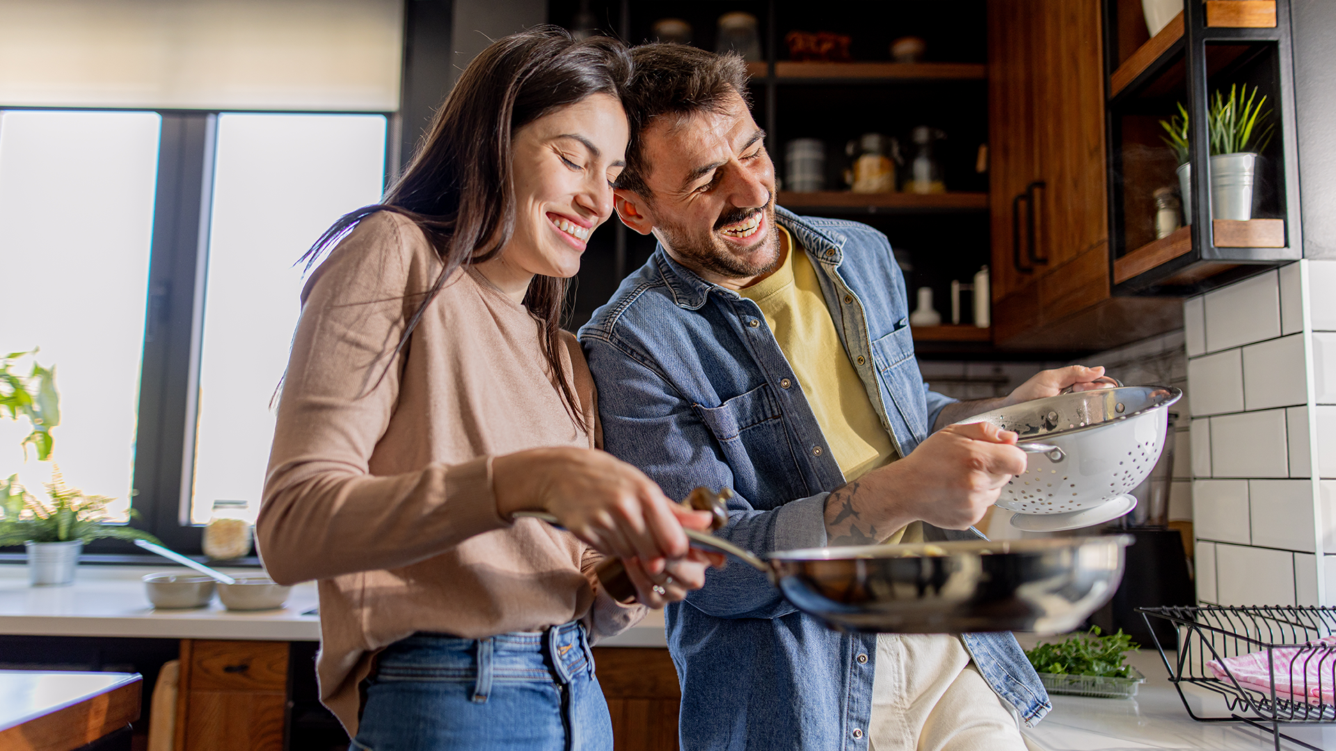 Couple smiling cooking