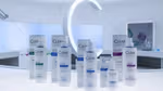 The full range of Clear’s ScalpCeutical’s bottles and packs on a white lab-style counter