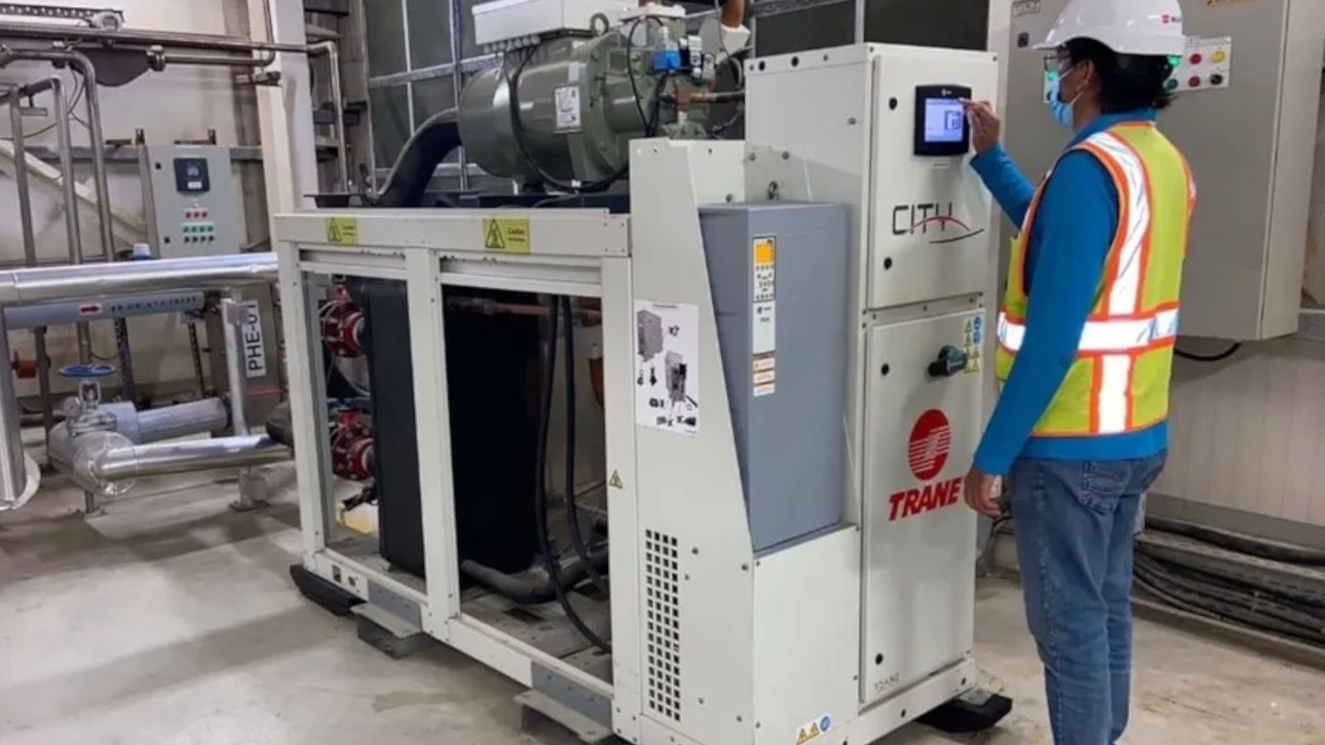 A factory worker programmes a heat pump in our Personal Care factory in Dubai.