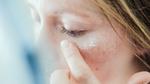 A person wiping their face