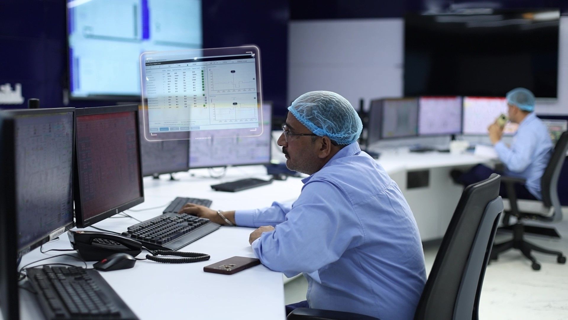 A factory team member works at a terminal 