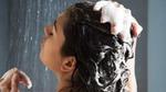 Woman shampooing hair in shower