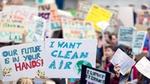 Image of children holding protest placards with Freedom to breathe on them