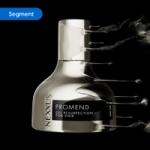 Nexxus Promend Oil Resurrection for Hair bottle in metallic silver with dynamic liquid splash effect on a black background.