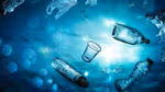 Underwater perspective of various plastic bottles, cups and shopping bags floating in the sea.