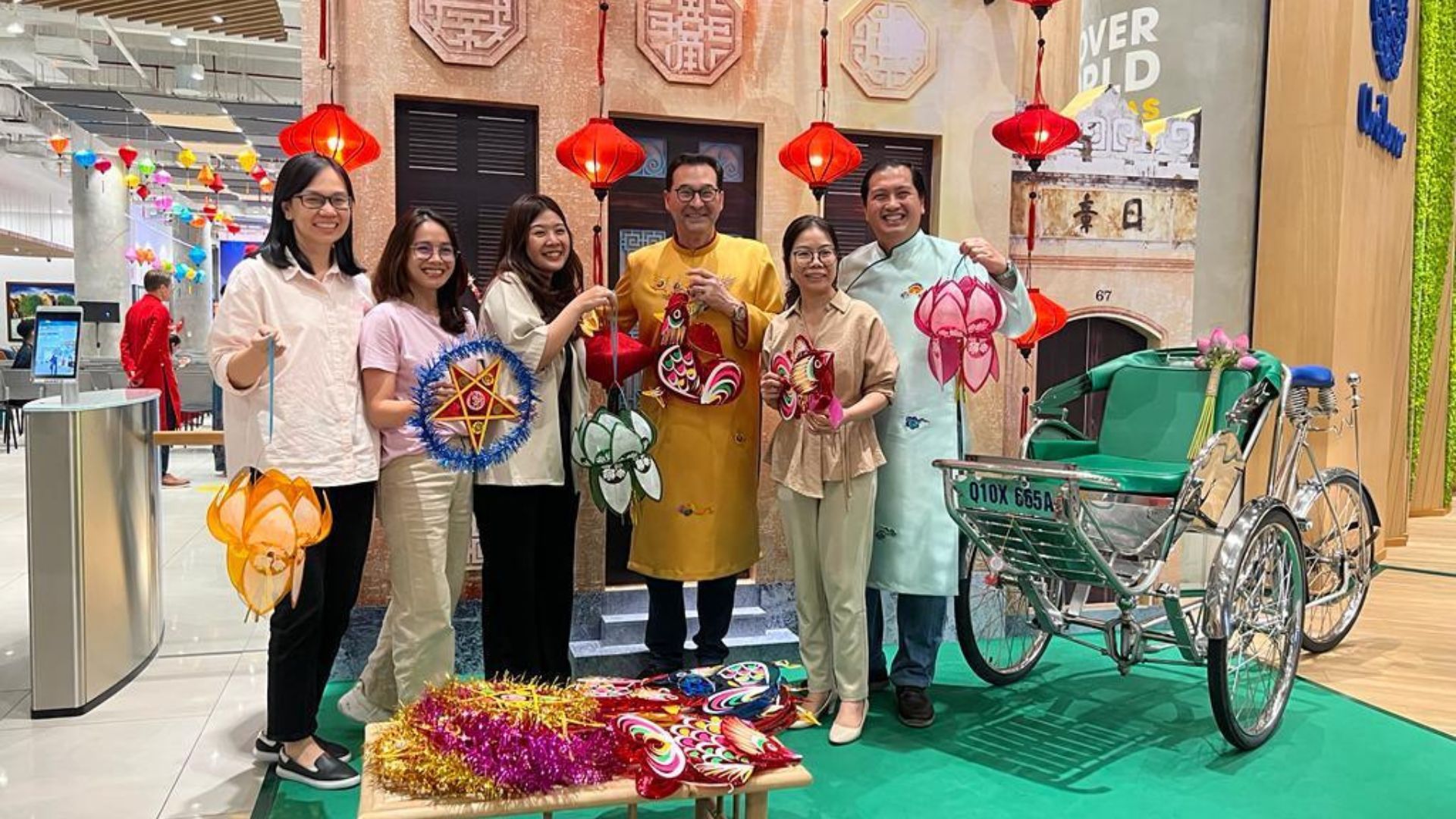 Fabian Garcia, President of Unilever Personal Care, wearing a yellow tunic and holding a lantern on a visit to Indonesia