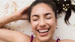 Woman lying with her eyes closed with her hair loosely covered with glittery dandruff