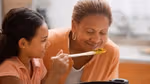 A grandmother and grandchild cooking