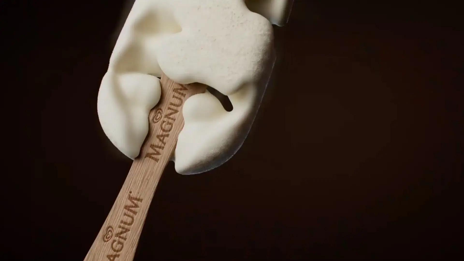 A magnum ice cream stick with vanilla ice cream pouring onto it