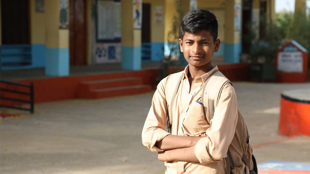 Photo of boy with crossed arms looking at camera