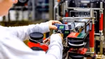 A close-up of a factory team member working on a Knorr production line
