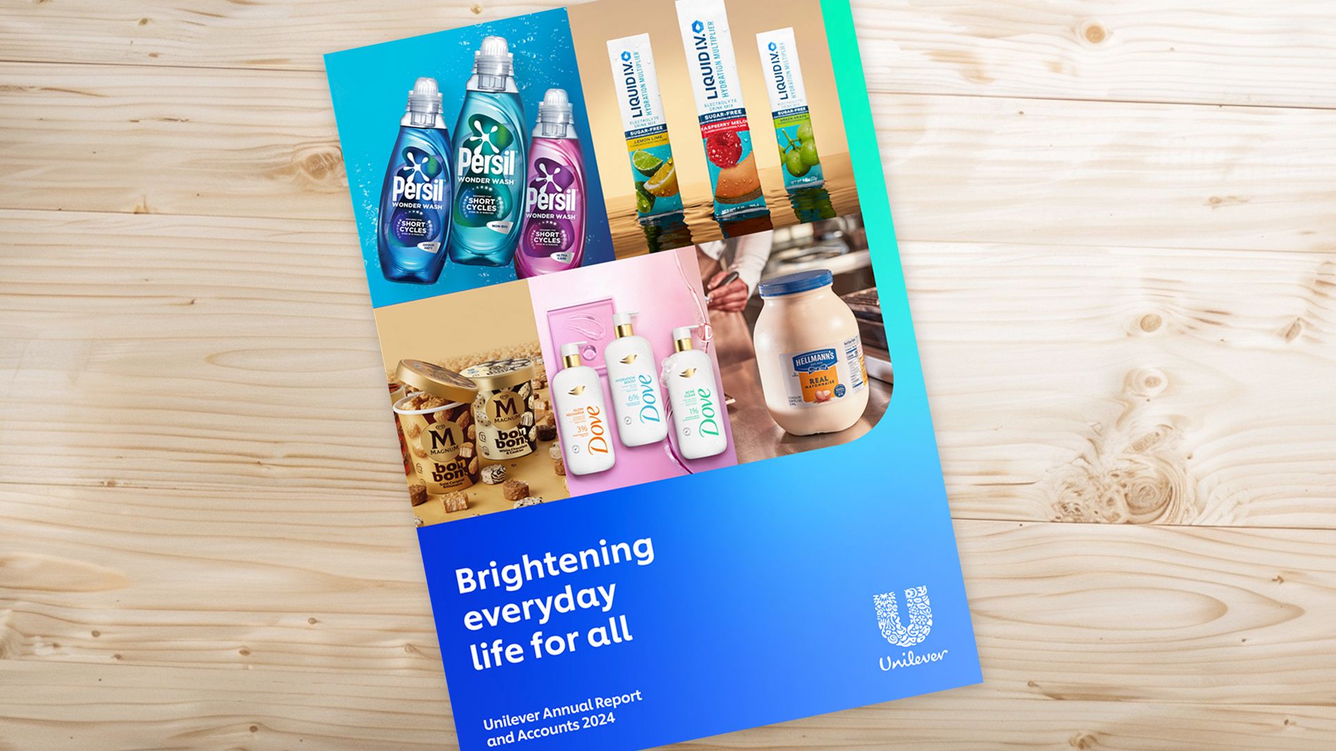 Unilever Annual Report and Accounts 2024 booklet placed on a light wooden desk, featuring product images of Persil detergents, Liquid I.V. hydration packets, Magnum ice cream, Dove body care, and Hellmann’s mayonnaise. The cover text reads “Brightening everyday life for all.”