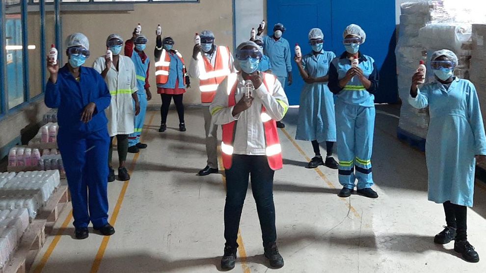 Unilever employees holding hand sanitizer in Africa