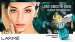 A model with dark hair and gold jewellery looks directly at the camera. The advert is for Lakme’s Lumi-Smooth AHA Serum.