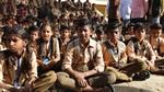 A group of schoolchildren sitting on the ground. Unilever works with UNICEF to improve sanitation in schools.