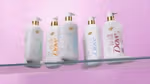 Shelf with five bottles of Dove’s new Serum Shower Collection of body washes, each designed to deliver skincare benefits